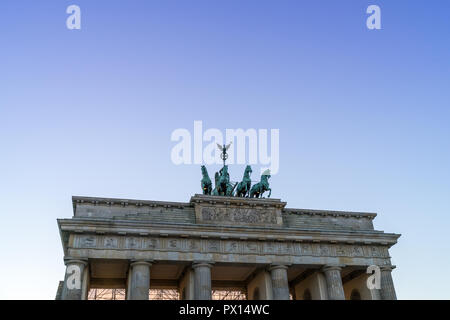 Berlin, Germany - September 30, 2018: View on the Brandenburg Gate (Brandenburger Tor) with a small black bird sitting on the monument during sunset Stock Photo