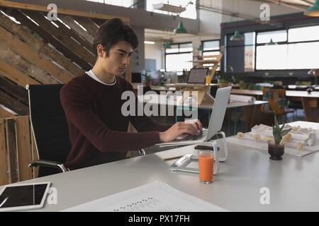 Male executive working on laptop Stock Photo