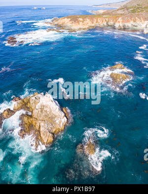 The cold, nutrient-rich waters of the Pacific Ocean swirl against the rocky and scenic coastline of Northern California not far from Monterey. Stock Photo