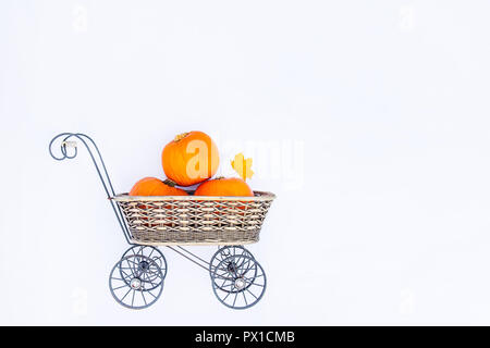 Top view Vintage Garden carriage basket with ripe pumpkins on the white background isolated . Autumn harvest, thanksgiving, halloween concept. healthy Stock Photo