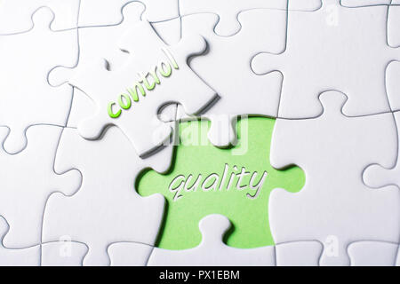 The Words Quality And Control In Missing Piece Jigsaw Puzzle Stock Photo