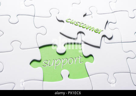 The Words Customer And Support In Missing Piece Jigsaw Puzzle Stock Photo