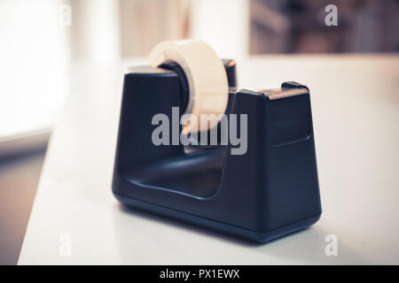 Black Sellotape Holder On A White Office Desk Stock Photo