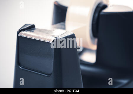 Macro Of A Black Sellotape Holder On A White Office Desk Stock Photo