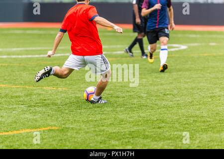 Playing Soccer Football Players in the Stadium Field during Match Competition showing Soccer Ball for Background Stock Photo