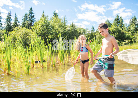 Happy brother and sister fishing at sea during summer vacation Stock Photo  - Alamy