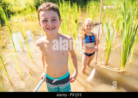 Happy brother and sister fishing at sea during summer vacation Stock Photo  - Alamy