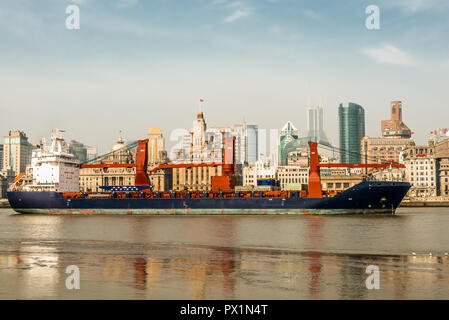 Shanghai, China - April 7, 2013: cargo ship on the bund waterfront Hangpu river at the city of Shanghai in China on april 7th, 2013 Stock Photo