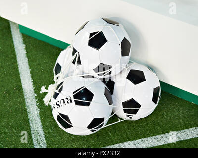 Classic soccer balls in a grid on a green football field lawn Stock Photo
