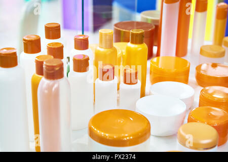 Plastic bottles and jars for cosmetics on showcase store Stock Photo