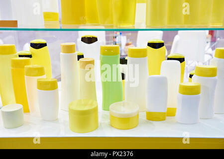 Plastic bottles and jars for cosmetics on showcase store Stock Photo