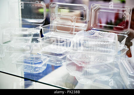 Plastic disposable food containers in showcase of shop Stock Photo