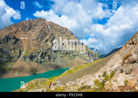 Beautiful landscape with emerald-turquoise mountain lake Ala-Kul, Kyrgyzstan.