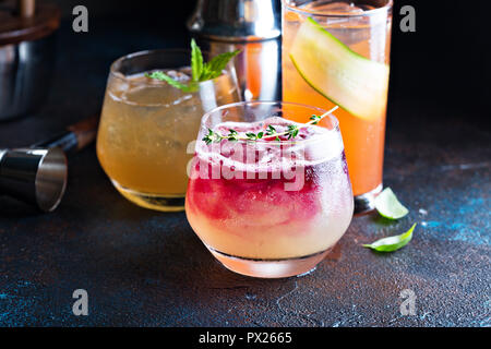 Variety of seasonal fall cocktails with citrus, apple cider, pomegranate syrup, whiskey and gin Stock Photo