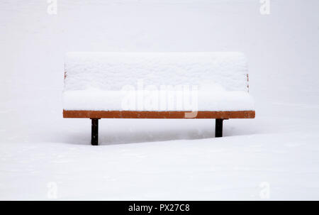 Snow covered bench during spring snow storm in Boulder, Colorado, USA. Stock Photo