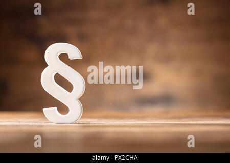 Close-up Of A White Paragraph Symbol On Wooden Desk Stock Photo