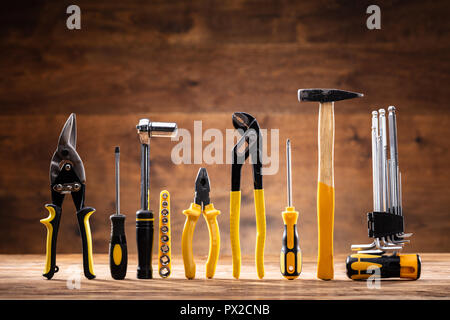 Row Of Various Worktools On Wooden Desk Stock Photo