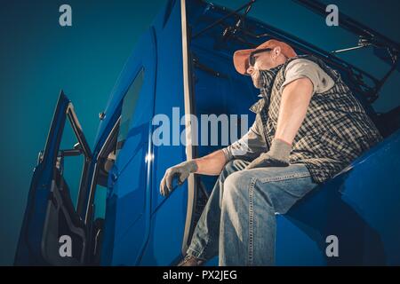 https://l450v.alamy.com/450v/px2jeg/truck-driver-cargo-transport-caucasian-men-seating-on-his-semi-tractor-and-enjoying-the-view-px2jeg.jpg