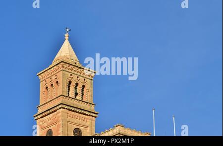 White Stork, Ciconia ciconia, migrating over the Maltese Islands. Big bird balancing resting on top of a tall Catholic Church bell tower, Birzebbuga. Stock Photo