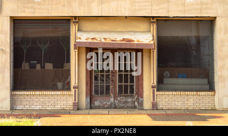 Some equipment shows through doors and windows covered with thick metal grate Stock Photo