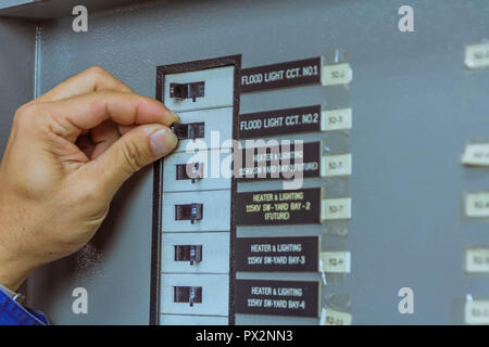 Male engineers are turn off breaker for check electrical system working. Stock Photo