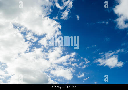 cloudy blue sky with gray clouds, nature background with blue texture and shapes of clouds, in the light of cloudy day. Stock Photo