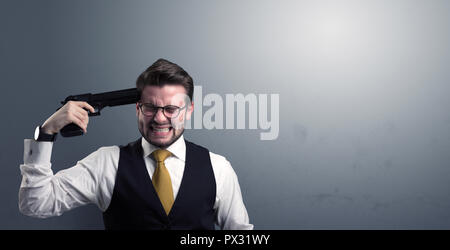 Young lost businessman man shooting his head with gun Stock Photo