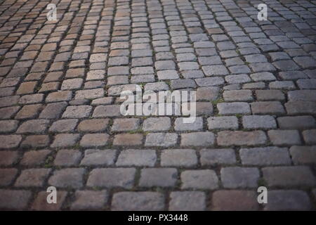 Background of Asymmetric Cobblestone Road Cobblestones in old centre of Berlin Stock Photo