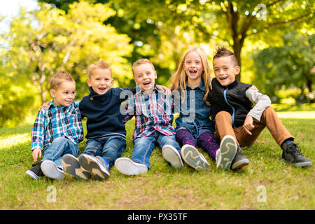A group of children in spring field having fun Stock Photo