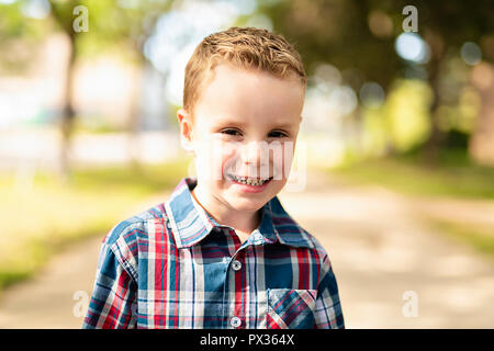 An nice adorable boy portrait outside standing Stock Photo