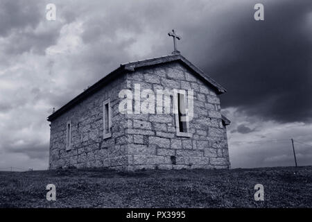 Old granite chapel. ANALOG: 35 mm film. Toned blue. Stock Photo