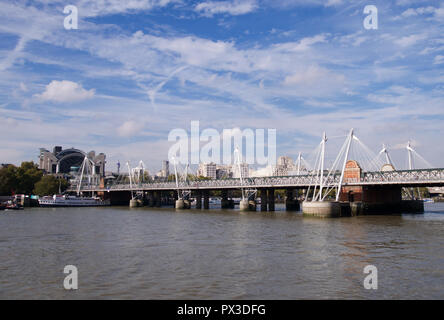 The Hungerford Bridge across the river thames, London, with the BT Tower in the distance Stock Photo