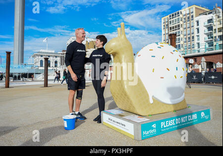 Brighton UK 19th October 2018 - Norman Cook aka Fatboy Slim is changing his name to Fatboy Slow during a 26 mile walk to visit all the giant snail sculptures around Brighton and Hove in one day helping to raise money for the Martlets Hospice . There are over 50 snail sculptures to visit covering a distance of 26 miles on the Snailspace Art Trail's fundraising #BeMoreSnail day Credit: Simon Dack/Alamy Live News Stock Photo