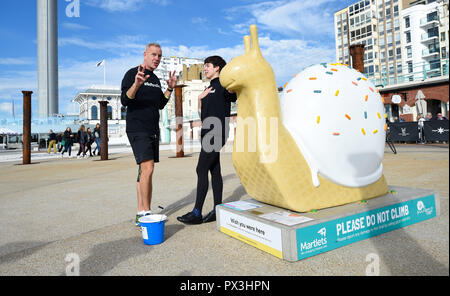 Brighton UK 19th October 2018 - Norman Cook aka Fatboy Slim is changing his name to Fatboy Slow during a 26 mile walk to visit all the giant snail sculptures around Brighton and Hove in one day helping to raise money for the Martlets Hospice . There are over 50 snail sculptures to visit covering a distance of 26 miles on the Snailspace Art Trail's fundraising #BeMoreSnail day Credit: Simon Dack/Alamy Live News Stock Photo