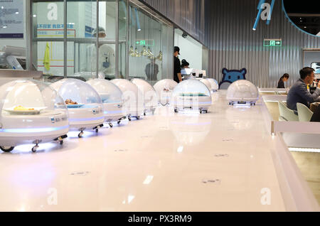 Shanghai. 15th Oct, 2018. AGV (automated guided vehicle) robots line up to serve food to customers in a smart restaurant operated by Chinese e-commerce giant Alibaba at the National Exhibition and Convention Center in east China's Shanghai, Oct. 15, 2018. Credit: Fang Zhe/Xinhua/Alamy Live News Stock Photo