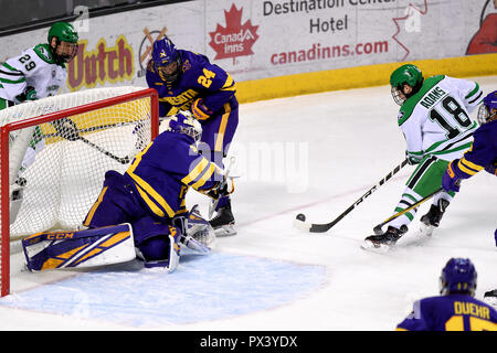 October 19, 2018 North Dakota Fighting Hawks forward Collin Adams (18) drives the net and Minnesota State Mavericks goaltender Dryden McKay (29) during a NCAA men's college hockey game between the Minnesota State Mavericks and the University of North Dakota Fighting Hawks at Ralph Engelstad Arena in Grand Forks, ND Mankato won 7-4. Photo by Russell Hons/CSM Stock Photo