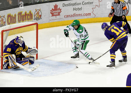 October 19, 2018 North Dakota Fighting Hawks forward Joel Janatuinen (25) attempts to shoot a puck on Minnesota State Mavericks goaltender Dryden McKay (29) as Minnesota State Mavericks forward Jared Spooner (11) blocks his stick during a NCAA men's college hockey game between the Minnesota State Mavericks and the University of North Dakota Fighting Hawks at Ralph Engelstad Arena in Grand Forks, ND Mankato won 7-4. Photo by Russell Hons/CSM Stock Photo