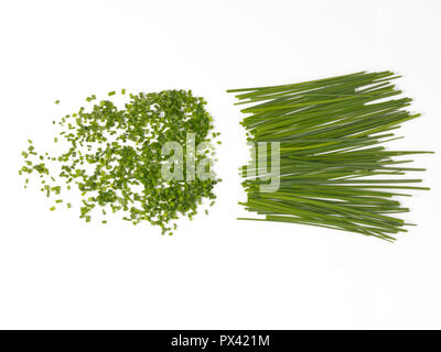 chopped and whole chives on a white background Stock Photo