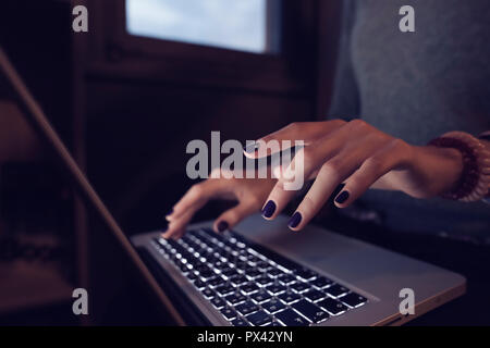 close up on hands using a laptop computer Stock Photo