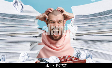 Frustrated overwhelmed executive working in the office and overloaded with paperwork, he is screaming and feeling depressed Stock Photo