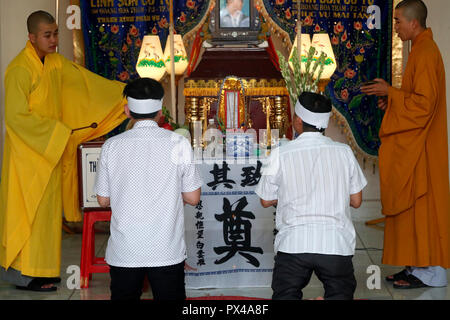 Linh Son Co Tu buddhist temple. Funerals. Men praying with monks.  Vung Tau. Vietnam. Stock Photo