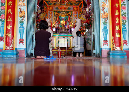 Mieu Ba Ngu Hanh buddhist temple.  Women praying.  Women praying.  Vung Tau. Vietnam. Stock Photo