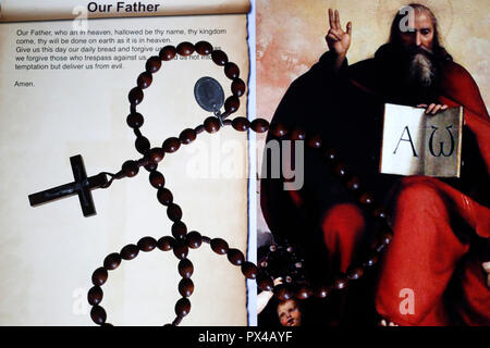 Christian Rosary on a digital tablet. Catholic prayer : Our Father. Stock Photo