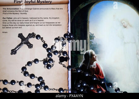 Christian Rosary on a digital tablet.  Catholic prayer. The First Joyful Mystery : the Annunciation. Stock Photo