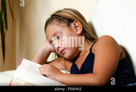 young girl reading a book Stock Photo