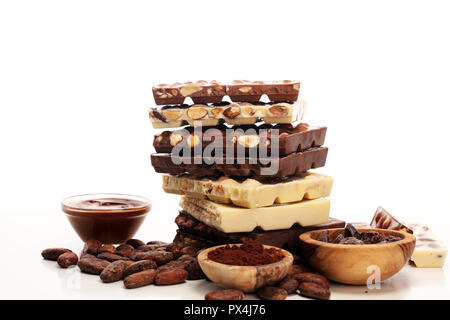 Chocolate bars on table with chocolate tower. Chocolate and nuts Stock Photo