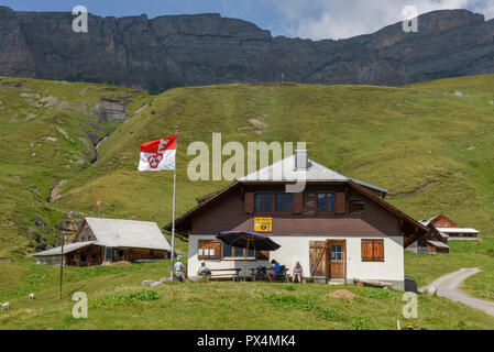 Tannen, Switzerland - 4 August 2018: people drinking on a alp cheese factory at Tannen on the Swiss alps Stock Photo