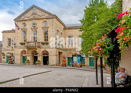 Colourful floral decorations adorn the imposing Town Hall in the Market Square at Wells, Somerset, England, UK Stock Photo