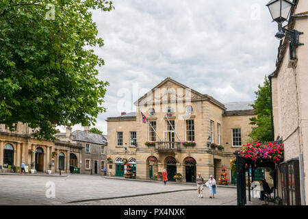 Colourful floral decorations adorn the imposing Town Hall in the Market Square at Wells, Somerset, England, UK Stock Photo