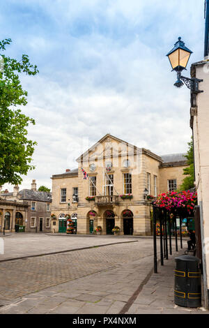 Colourful floral decorations adorn the imposing Town Hall in the Market Square at Wells, Somerset, England, UK Stock Photo